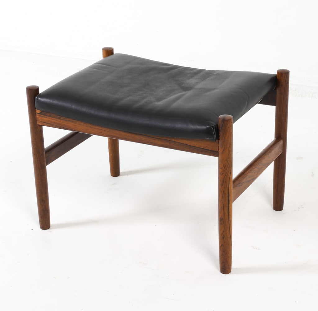 HUGO FRANDSEN SPOTTRUP ROSEWOOD & LEATHER OTTOMAN: Stamped to underside. Denmark, 1970s. Dimensions: H 15" x W 21" x D 15". Condition: Creases to leather. Minor scuffs to frame. Wear consistent with age and use. GCD033