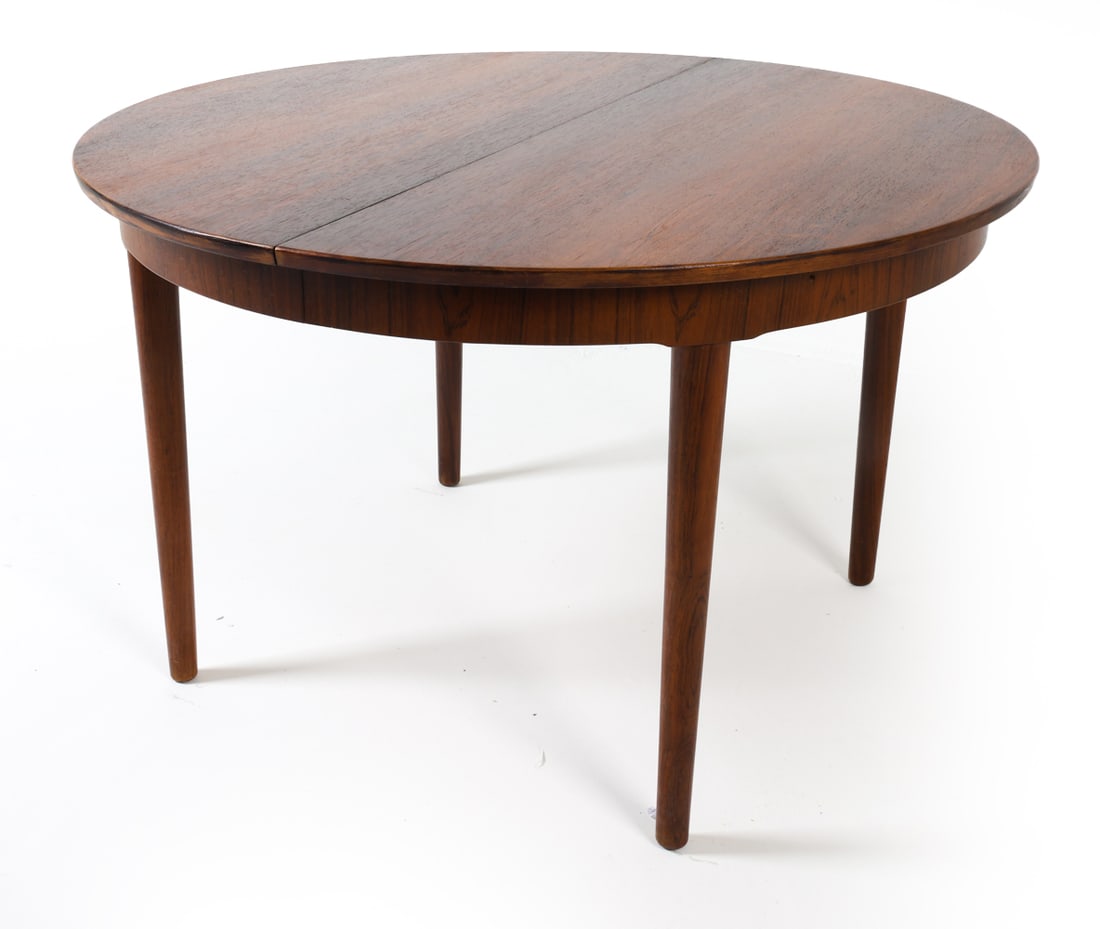 SEVERIN HANSEN ROSEWOOD EXTENDING DINING TABLE: (3) Leaves included. Denmark, circa 1960s. Dimensions: H 29.5" x Dia. 47.25". Leaf W 19.75". Full W 106". Condition: Scuffs and rubs to some of the leaves, with a few faint water rings. GCD153
