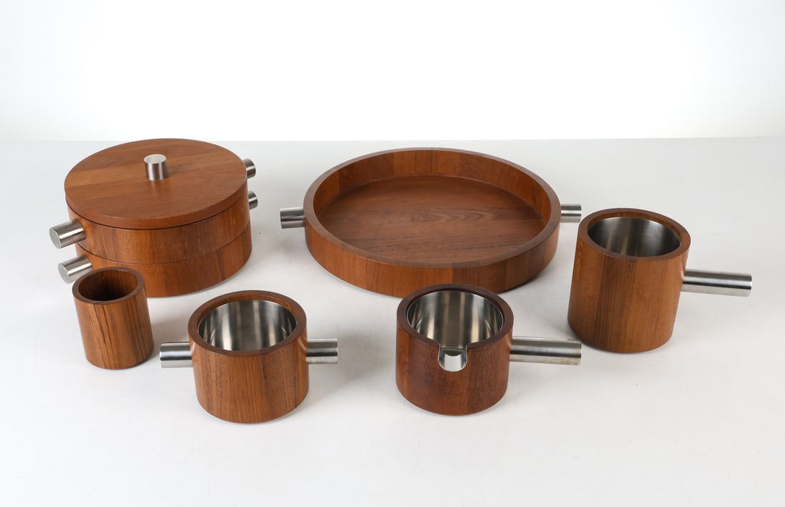 COMBIWOOD LUNDTOFTE DANISH TEAK SERVINGWARE: Teak wood with stainless steel handles and inserts. Includes (6) pieces. Marked under bases. Denmark, circa 1960s. Dimensions: Tray H 2.5" x Dia. 15". Ice Bucket H 5.5" x Dia. 13". Condition: Light sc