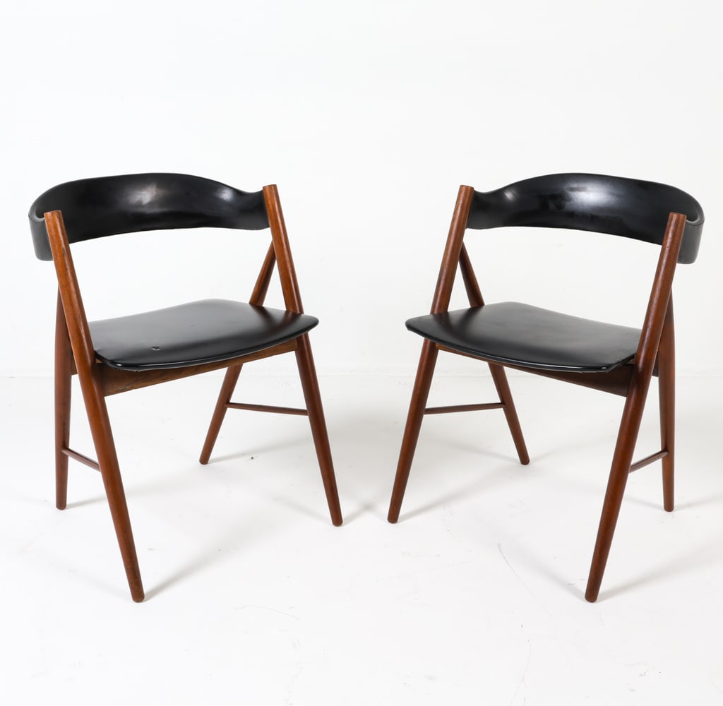 PAIR OF KIERKEGAARD STYLE DANISH TEAK CHAIRS: Danish. Circa 1970s. Black leather upholstery. Dimensions: H 28" x W 19.5" x D 18" Condition: Slight indentations to seat upholstery. Rubbing to finish on arms. Wear consistent with age and use. GCD22