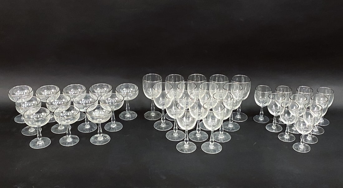 MID-CENTURY PLATINUM RIM WINE GLASS & GOBLETS: Includes (14) 7" wine glasses, (10) 5.5" wine glasses, and (12) 5" champagne saucer glasses. All unmarked, with platinum-toned rims. Condition: Some loss of the platinum to rims. Light surface marks,