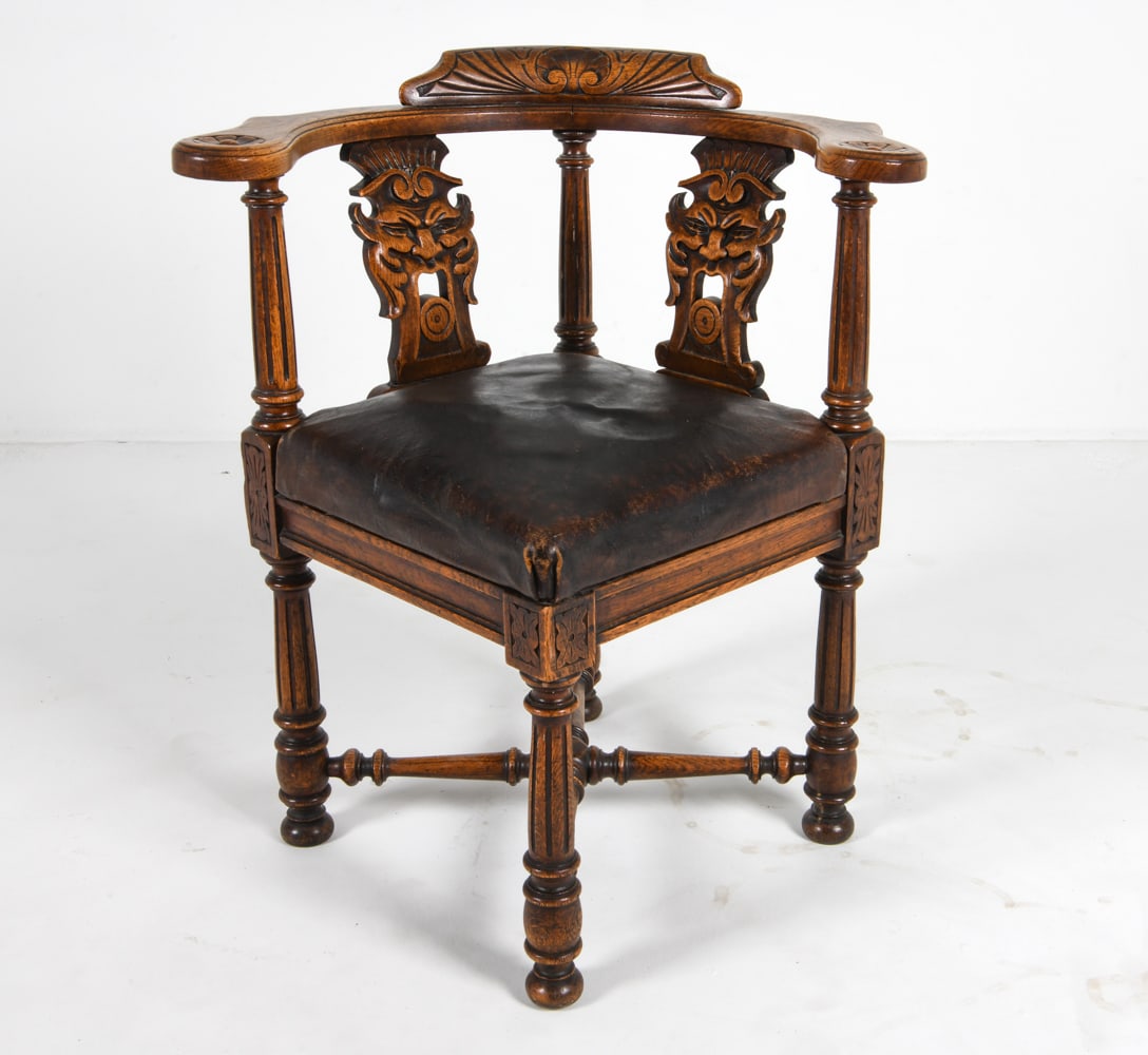 ANTIQUE SCANDINAVIAN OAK & LEATHER CORNER CHAIR: Scandinavian, early 20th. Dimensions: H 33" x W 27.5" x D 23.5" x SH 19.5". Condition: Some rubbing and fading to arms. Some rubbing to leather, slight drying and dents. Wear consistent with age and u