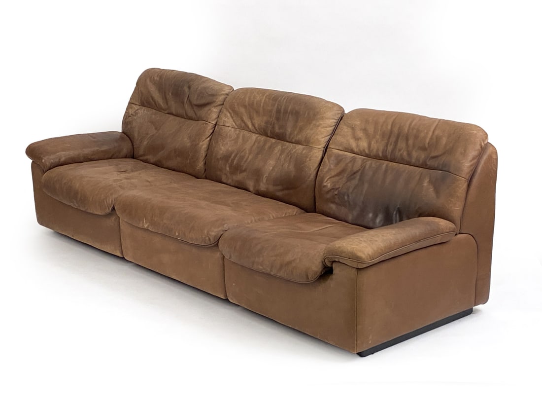 DE SEDE DS-66 LEATHER 3-SEATER SOFA, C. 1970S: Marked on underliner, with serial number on a tag. Dimensions: H 30" x W 91" x D 32" x SH 14" Condition: Scratches and scuffs throughout leather. PM166