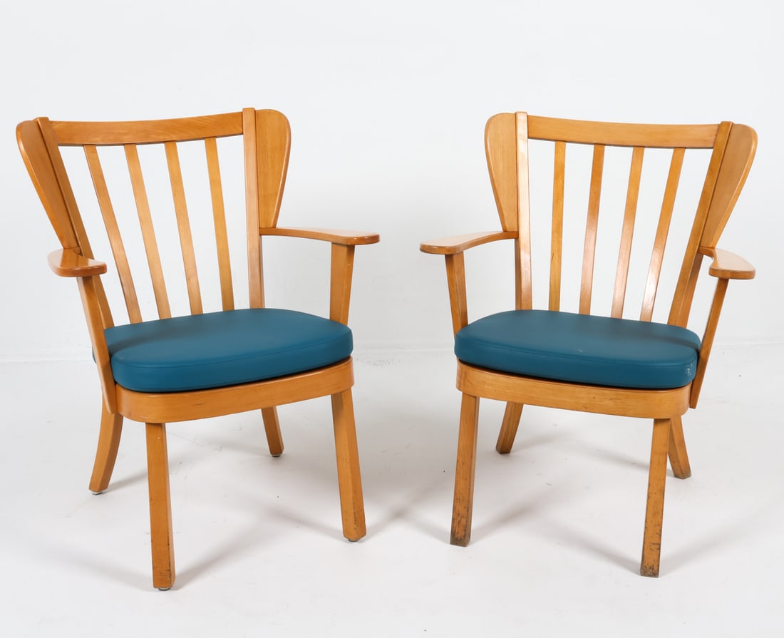 PAIR OF FRITZ HANSEN CANADA CHAIRS: One stamped to underside. Beech frames with leather cushions. Denmark, Circa. 1940s Dimensions: H 31" x W 25.25" x D 19", SH 14.5" Condition: Scattered marks and scuffs to armrests and legs. Wear cons