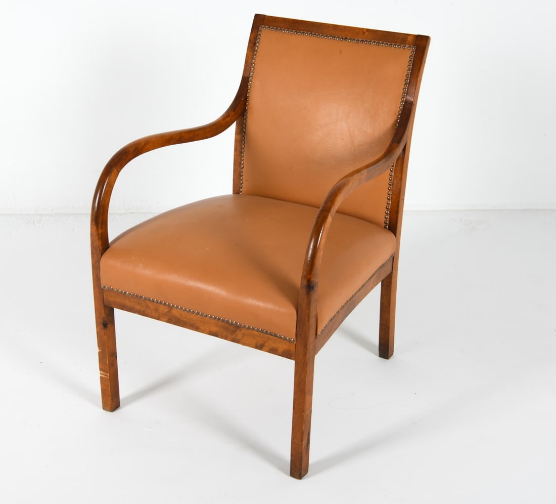 FRITS HENNINGSEN STYLE LEATHER & WALNUT CHAIR: Cognac-tone leather with brass tack edges. Denmark. Circa 1960s Dimensions: H 33.5" x W 22" x D 23", SH 17" Condition: Scattered nicks and dings on leather seat. Leather seat back has slight blemishes