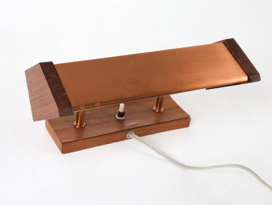 JO HAMMERBORG 'FUGA' TEAK & COPPER WALL LIGHT: For Fog & Morup. Teak veneer with copper accents to shade. Tilting design to adjust position of light. Denmark, circa 1960s. Dimensions: H 5.75" x W 10.5" x D 5.5". Condition: Some losses to veneer, m