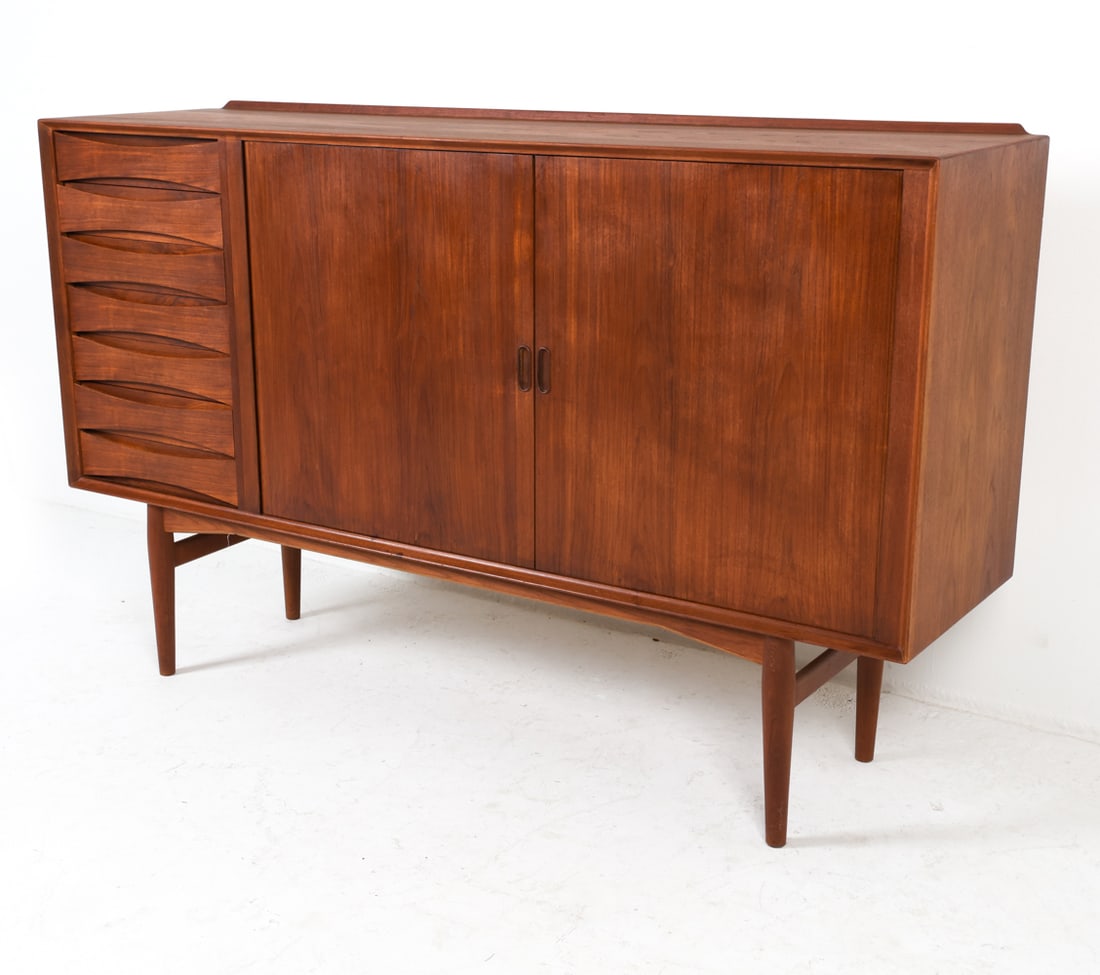 ARNE VODDER DANISH TEAK TAMBOUR SIDEBOARD C. 1960S: Sliding tambour cabinet doors with adjustable shelves inside. Drawers with atomic-shaped fronts. Denmark, circa 1960s. Dimensions: H 45" x W 71.5" x D 19.75". Condition: Very light wear consistent wit