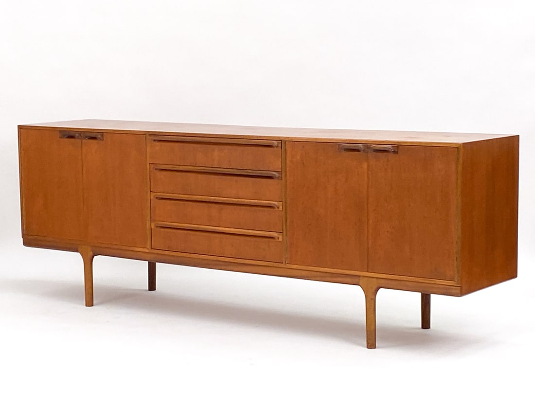TOM ROBERTS FOR A. H. MCINTOSH TEAK SIDEBOARD: Danish modern style cabinet designed by Tom Robertson for A.H. McIntosh & Co's "Dunbar" line. Figured teak top with rosewood handles. Scotland, circa 1965. Signed inside drawer. Dimensions: H 30" x W