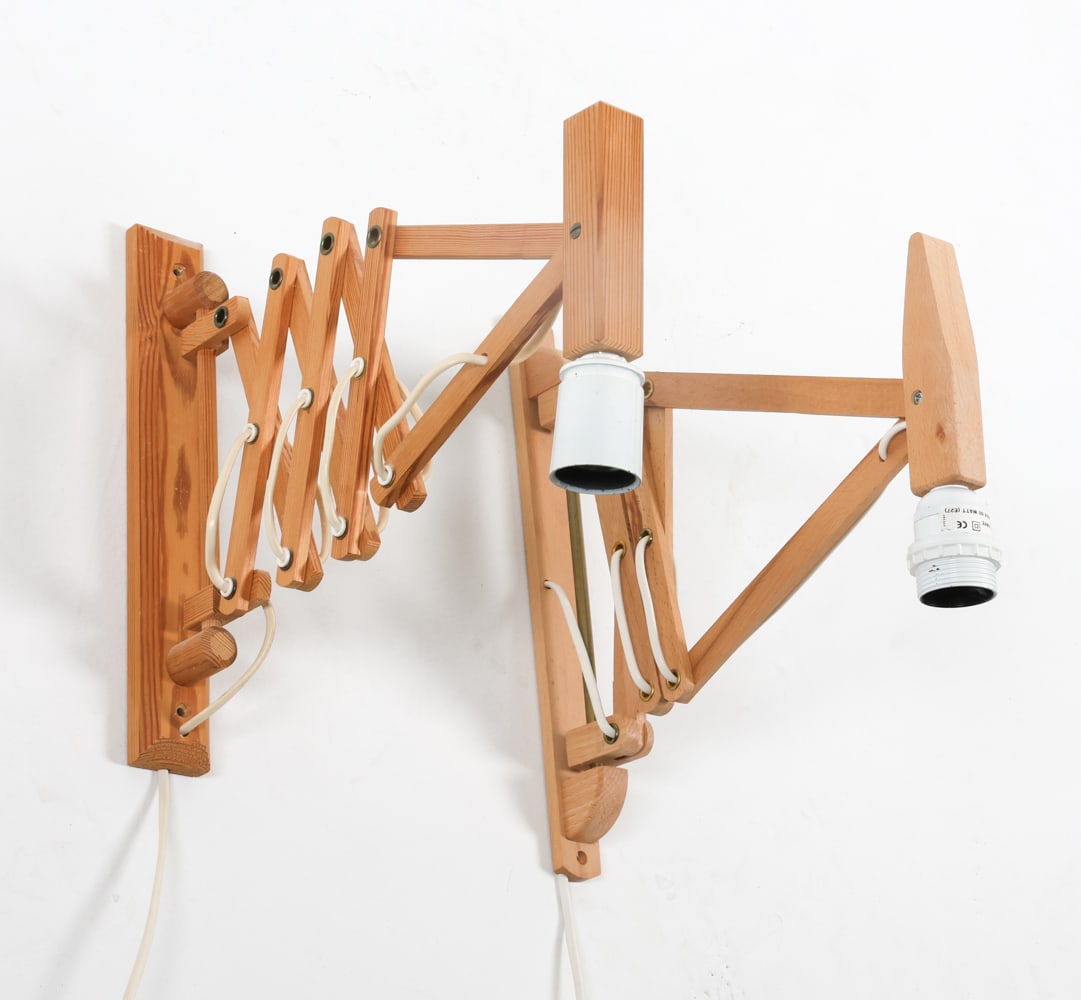 DANISH PINE SCISSOR WALL SCONCES C. 1960S: (2) in total. One marked Danalux. Dimensions: (largest) H 12" x W 1.75" x D 13.5" Condition: Minor scuffs. Both with European plugs. Untested. Presents well overall.