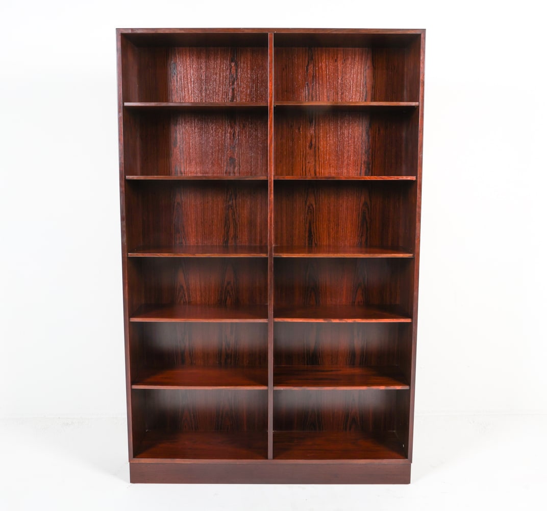 GUNNI OMANN JUN DANISH ROSEWOOD BOOKCASE C. 1960S: Designed by Gunni Omann for Omann Juniors Mobelfabrik. Tag on back top corner. Adjustable shelves. Denmark, circa 1960s. Dimensions: H 74.5" x W 47.25" x D 11.25". Condition: Presents well overall. JE