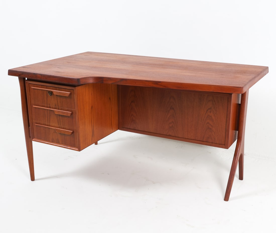 ARNE VODDER DANISH TEAK WRITING DESK C. 1960S: Key included. Dimensions: H 29" x W 53" x D 32.5". Condition: Faint sun fading to top, front compartment. Wear consistent with age and use. JE B192