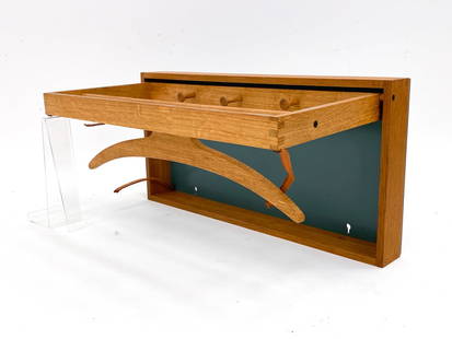 ADAM HOFF & POUL OSTERGAARD COAT RACK: Oak and lacquered oak frame. Designed by Adam Hoff and Poul Ostergaard and manufactured by Virum Mobelsnedkri Rasmussen & Brygger. Label on verso. Denmark, circa 1960s. Dimensions: H 10.75" x W 21.5"