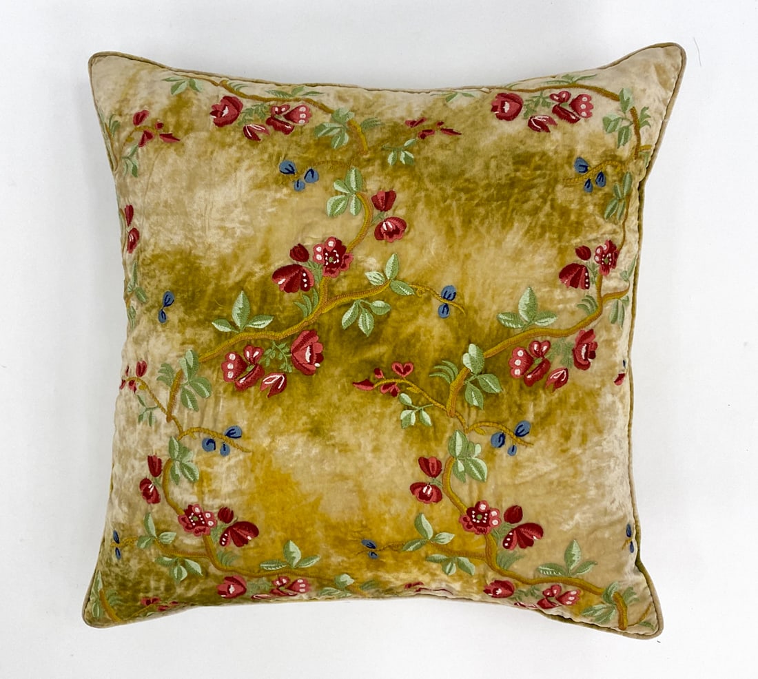 ANKE DRECHSEL EMBROIDERED VELVET PILLOW: Labeled to backside. Floral accents hand embroidery on green/yellow velvet. With down filling. Dimensions: H 18" x W 19" Condition: Minor loose threads. Presents well overall.