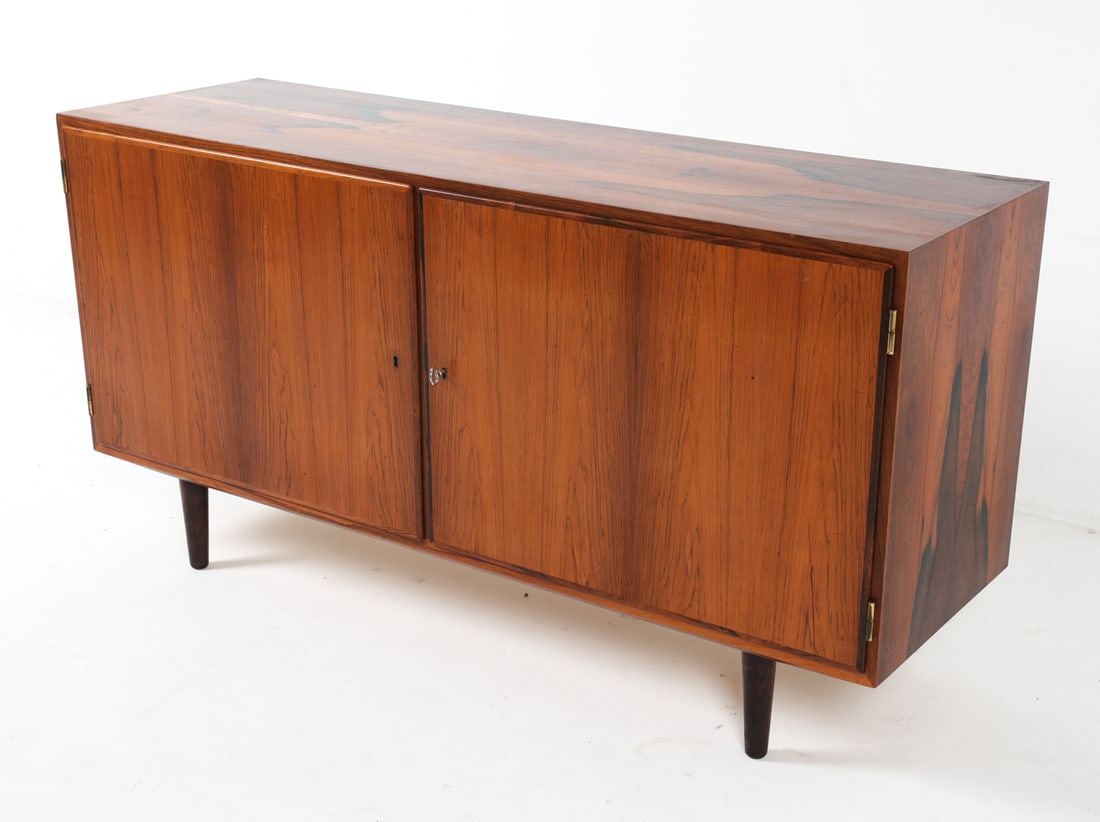 HUNDEVAD DANISH ROSEWOOD SIDEBOARD C. 1960S: Key included. Marked to back top corner. Adjustable shelves and drawers. Top drawer has felted bottom. Dimensions: H 28.5" x W 54" x D 17". Condition: Few minor dings and scuffs. Wear consistent with 