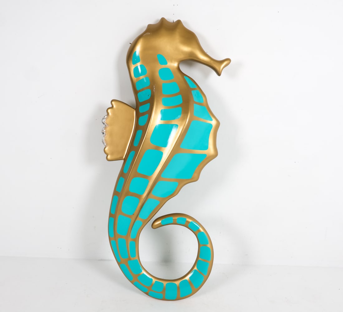 LARGE C. WONDER SEAHORSE SCULPTURE: With hanging hardware. Crafted plaster with teal sticker pattern. Dimensions: H 67" x W 9.5" x D 30" Condition: Moderate scuffs and scratches on gold paint decoration and loses to sticker on surface.