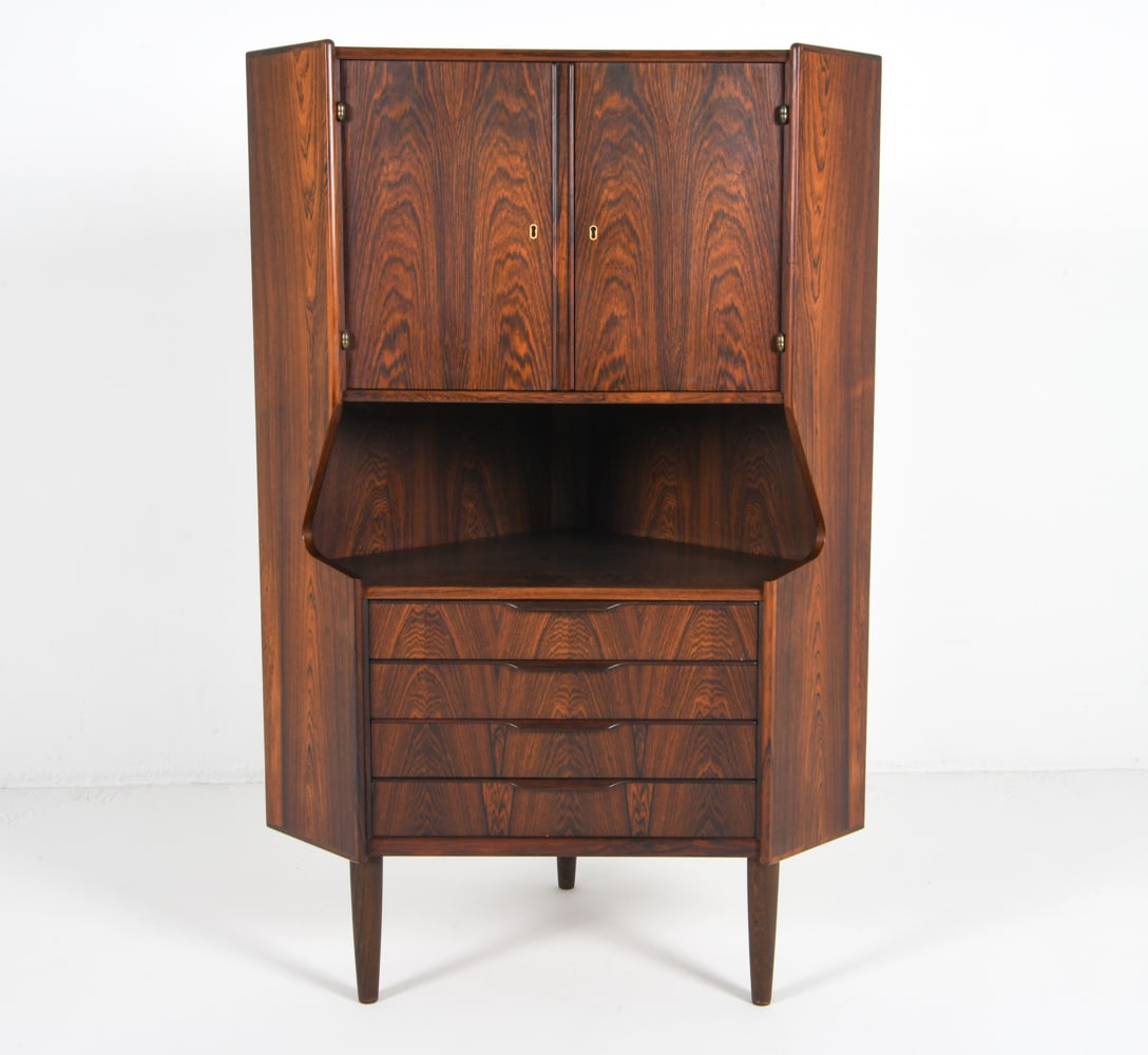 OMANN JUN DANISH ROSEWOOD CORNER CABINET C. 1960S: Key included. Corner cabinet with dry bar in top. Frosted decorated mirror. Denmark, circa 1960s. Dimensions: H 53.25" x W 36" x D 22.5". Condition: Faint surface scratches. Wear consistent with age a