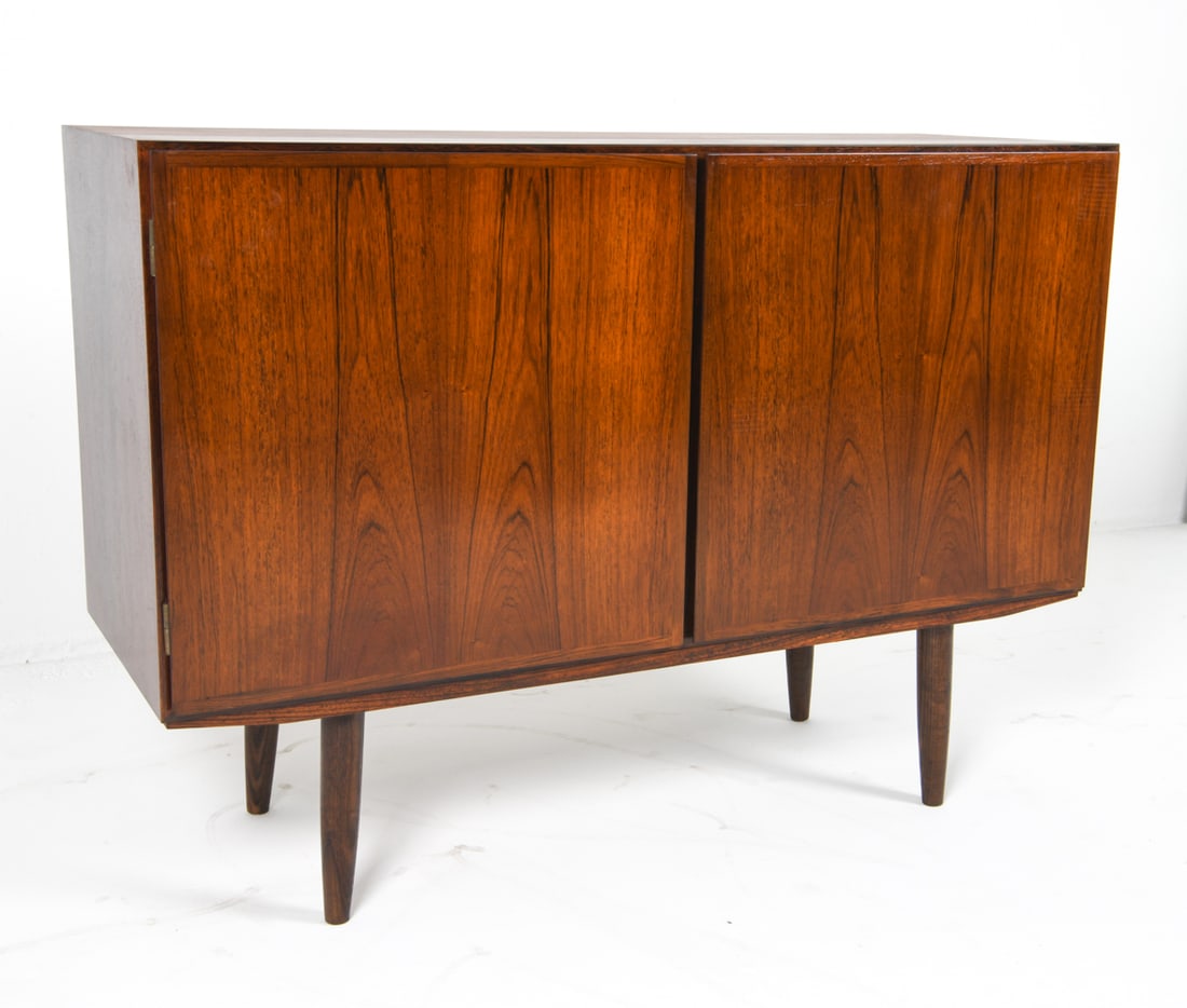 OMANN JUN MODEL 4 DANISH ROSEWOOD SIDEBOARD: Rosewood sideboard cabinet. Adjustable shelves and drawers. Tag inside cabinet. Denmark, circa 1960s. Dimensions: H 34" x W 47.25" x D 17". Condition: Few faint surface scratches. Wear consistent with