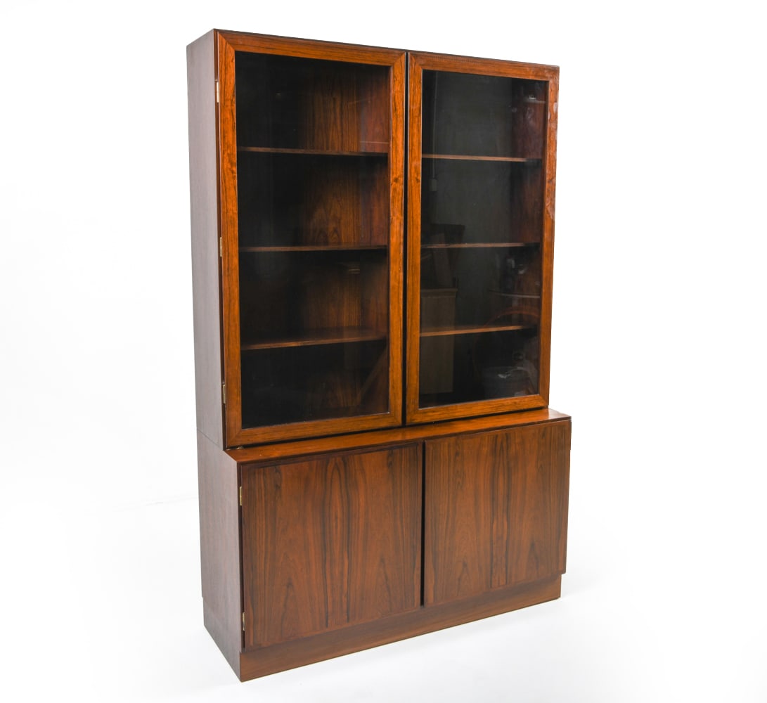 OMANN JUN MODEL 4 ROSEWOOD CABINET: Tag inside cabinet. Cabinet with glass cabinet doors, sits freely on cabinet base. Adjustable drawers. Denmark, circa 1960s. Dimensions: As Displayed H 74" x W 47.5" x D 17.25". Base H 27.5". Conditio