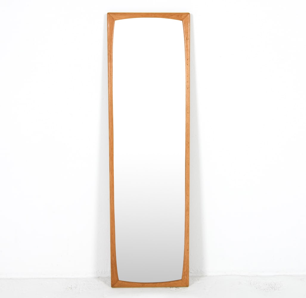 FROSEKE SWEDISH OAK WALL MIRROR C. 1960S: Label to backside. Dimensions: H 45.5"x W 13.25" Condition: Scattered marks and scuffs to frame. Wear consistent with age and use.