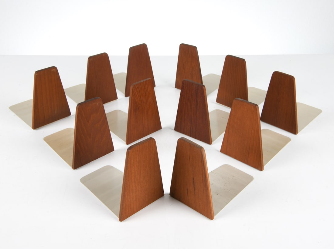 KAI KRISTIANSEN TEAK BOOKEND GROUPING C. 1960S: Dimensions: H 5.5" x W 4" x D 5.75". Condition: Minor scuffs to wood and metal. Wear consistent with age and use.