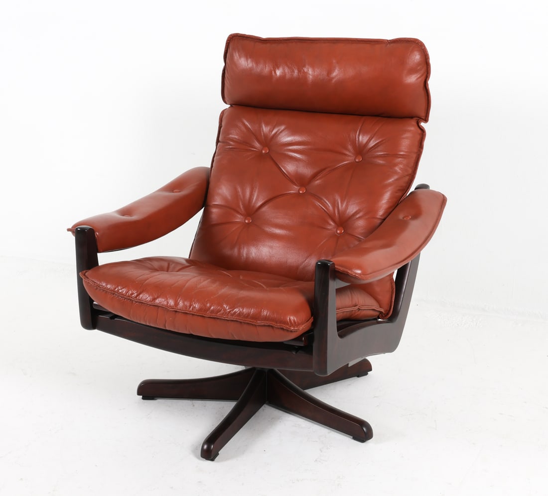 LIED NORWEGIAN LEATHER LOUNGE CHAIR: Beech swivel reclining lounge chair with cognac leather upholstery. Circa 1970s. Dimensions: H 37.25" x W 31.25" x D 30.5" x SH 17.75". Condition: Few scuffs and scratches to wood. Minor scuffs to lea