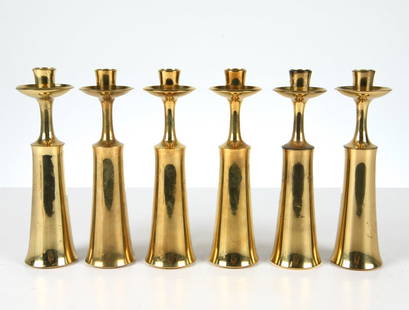 JENS QUISTGAARD FOR DANSK BRASS CANDLEHOLDERS: Includes (6) brass candleholders. Dimensions: H 9.75" x Dia. 2.25". Condition: Scuffs, and scratches. Dent to one. Wear consistent with age and use.