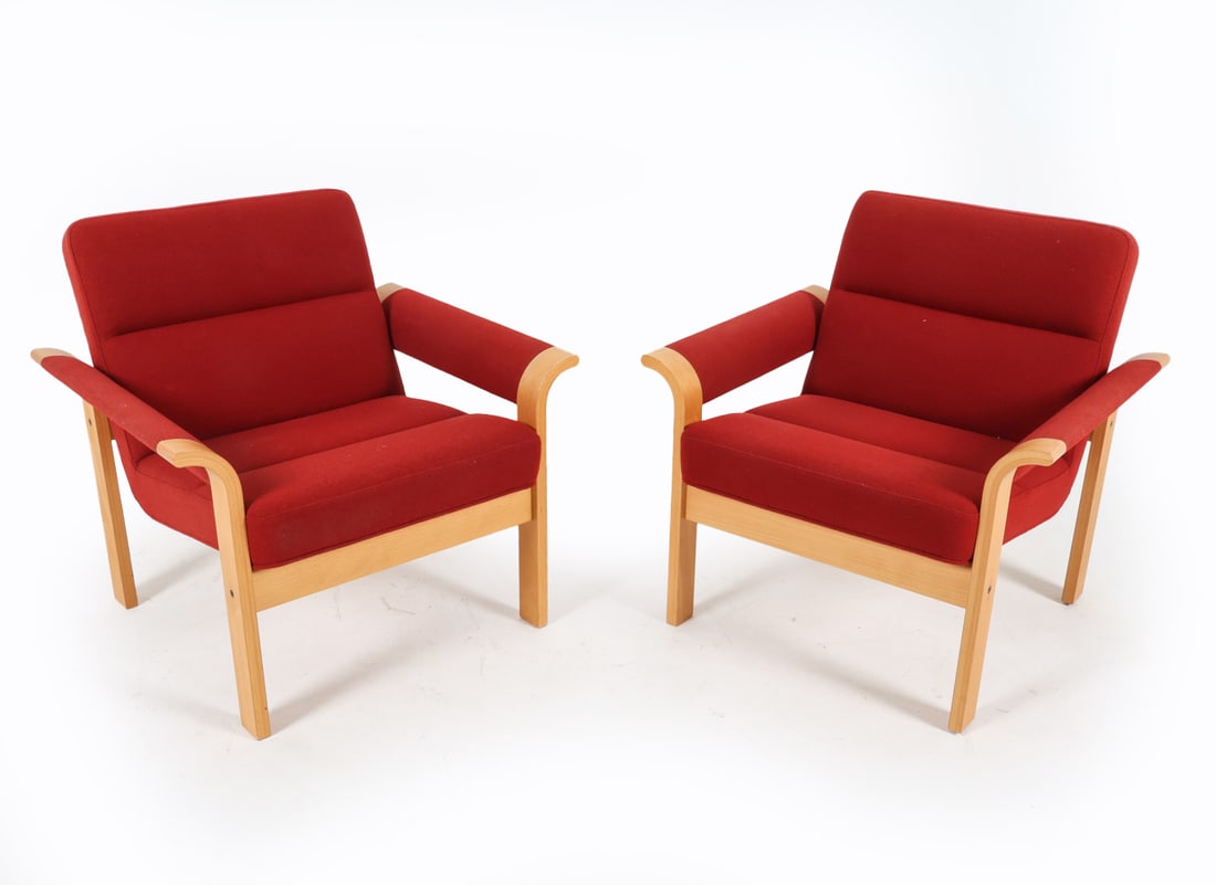 PAIR MAGNUS OLSEN BEECH LOUNGE CHAIRS C. 1970S: Label to underside. Demark. With red-tone wool upholstery. Dimensions: H 30" x W 30" x D 26", SH 16" Condition: Minor rubbing and scuffs to frames. Presents well overall. GCE035