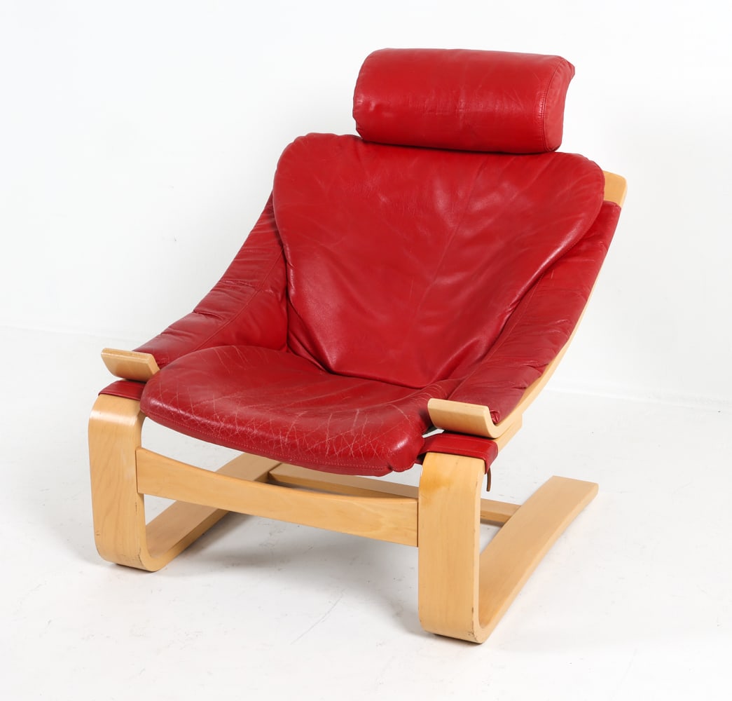 AKE FRIBYTTER LEATHER 'KROKEN' CHAIR C. 1970S: Pine frame with red-tone leather upholstery. Dimensions: H 35" x W 29.5" x D 31", SH 15" Condition: Moderate creases to leather. Nicks and dings to armrests. Wear consistent with age and use. GCE 185