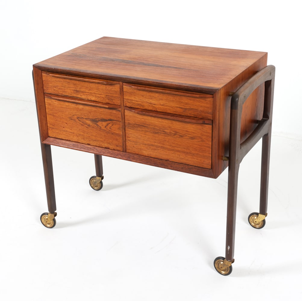 ARNE VODDER STYLE DANISH ROSEWOOD SEWING CHEST: Mounted on brass casters. Dimensions: H 25" x W 28" x D 16.5" Condition: Slight sun fading to surface. Light nicks and dings to edges. Casters partially stick. Presents well overall. GCE 186