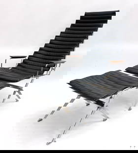 GERALD MCCABE SILHOUETTE LOUNGE CHAIR & OTTOMAN: For Brown Saltman. With black vinyl sling cushions and chair with walnut armrests. Apparently unmarked. Dimensions: ( Chair) H 44" x W 27" x D 24" x SH 18" (Ottoman) H 16.5" x W 23.5" x D 18.5" Condit