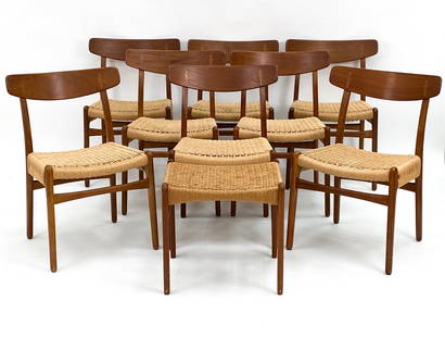 (8) HANS WEGNER CH-23 TEAK & RATTAN DINING CHAIRS: Signature Hans Wegner chairs with rattan wrapped seating and teak frames. Includes one ottoman/footstool. Apparently unmarked. Dimensions: (Chairs) H 30" x W 20" x D 19" x SH 17.5" (Ottoman) H 17.5" x