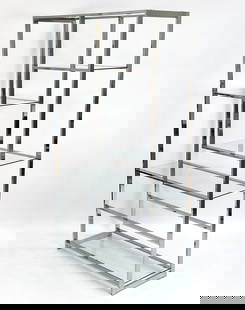MILO BAUGHMAN STYLE CHROME & GLASS ETAGERE: Geometric shelving pattern with a chrome frame and (5) glass shelves. Apparently unmarked. Dimensions: H 75" x W 42" x D 16" Condition: One epoxy repair to a shelf tab. Lacking (2) glass shelves. Ligh