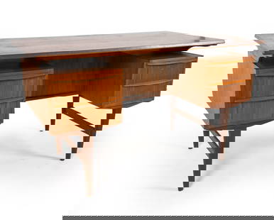 DANISH TEAK WRITING DESK C. 1960S: Key included. Teak desk with floating top design. Tapered legs. Dimensions: H 29.25" x W 51" x D 27.25". Condition: Some sun fading to top. Scuffs and scratches. Spots of discoloration. Wear consisten