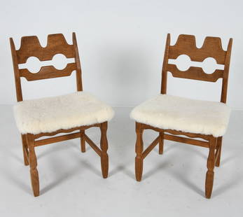 PAIR OF HENNING KJAERNULF RAZORBLADE DINING CHAIRS: Oak frames with iconic Razorblade seat backs. White boucle wool upholstered seats. Denmark, circa 1970s. Dimensions: H 33.5" x W 21.5" x D 17.5" x SH 18.25". Condition: Minor scuffs and dings to wood.