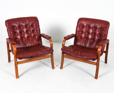 PAIR OF GOTE MOBLER SWEDISH BEECH LOUNGE CHAIRS: Beech bentwood frames with cognac leather cushions. Tags to backs of tops. Sweden, circa 1970s. Dimensions: H 29" x W 25.25" x D 30" x SH 14.5". Condition: Minor scuffs and scratches to frames. Wear c