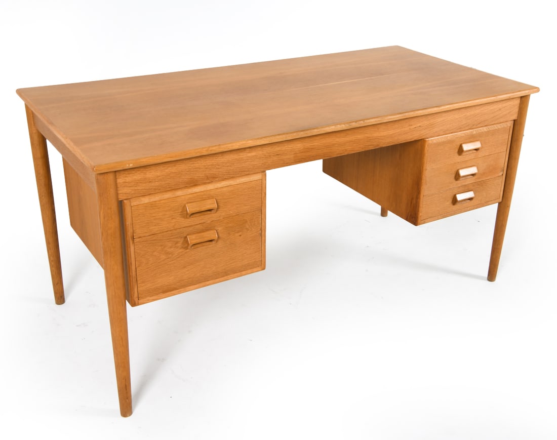 DANISH OAK WRITING DESK C. 1970S: Dimensions: H 29" x W 57.25" x D 28.5". Condition: Some chipping/peeling to veneer within underside. Wear consistent with age and use. PER E099