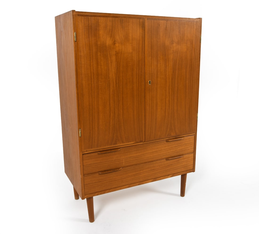 MID-CENTURY DANISH TEAK CABINET C. 1960S: Includes (1) key. Adjustable shelves. Dimensions: H 46.5" x W 30.5" x D 16" Condition: Nicks and dings to outer edges. Surface scuffs and marks. Wear consistent with age and use. PER E078