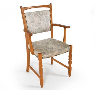 HENNING KJAERNULF STYLE OAK ARMCHAIR C. 1970S: Oak frame with botanical fabric upholstery. Denmark, circa 1970s. Dimensions: H 37" x W 23.25" x D 17" x SH 18.25". Condition: Few water spots to wood. Faint discoloration to seat. Wear consistent wit