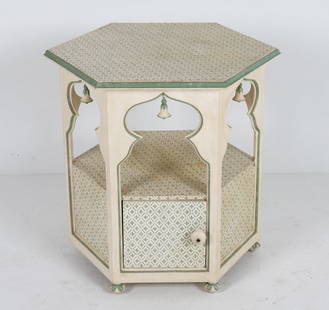 PAINT DECORATED MOORISH STYLE SIDE TABLE: Octagonal form with faux bells. Dimensions: H 27" x W 27.5" x 24" Condition: Scattered nicks, marks and rubbing to paint. Slight surface discoloration. Door hinge may requir repair. Wear consistent wi