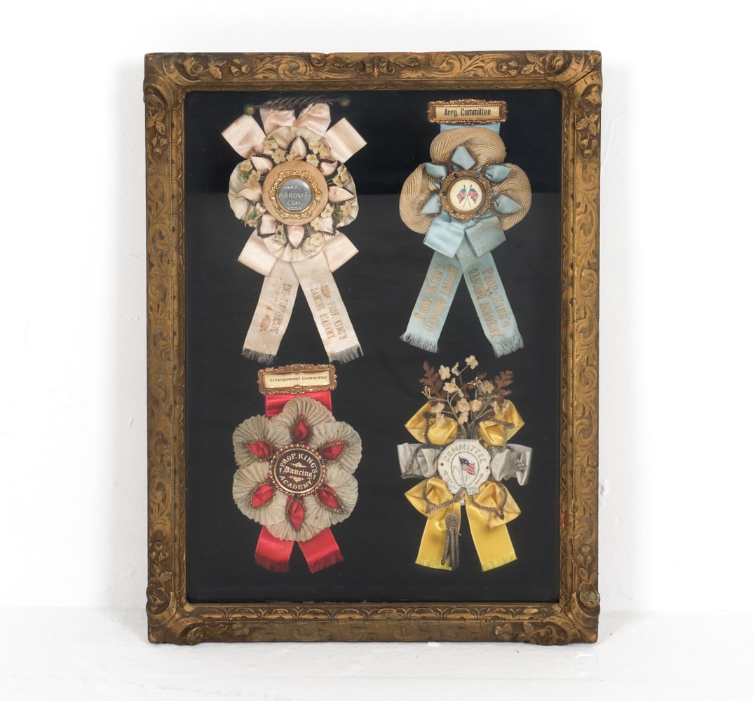 ANTIQUE DANCING ACADEMY AWARD RIBBONS: 4 mounted antique silk and satin ribbons. Frame: H 16" x W 12" x D 1.75" Condition: Some fading and slight blemishes to ribbons. Frame to shadow box may require reaffixing. Wear consistent with age an