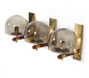 GERMAN BRASS & GLASS WALL SCONCES C. 1960S: Grouping of (3) brass & glass sconces with teak accents. Germany, circa 1960s. Dimensions: H 8.5" x W 6" x D 8". Condition: Wiring untested. Wear consistent with age and use. PN135