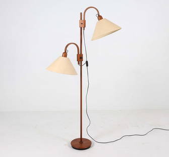 DOMUS DANISH TEAK FLOOR LAMP C. 1970S: Teak floor lamp with (2) adjustable lamp heads. Dimensions: H 66" x Dia. 28". Condition: Wiring untested, European plug. Lower lamp head may need adjustment to height knob. Wear consistent with age an