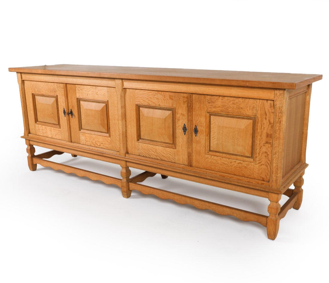 KJAERNULF STYLE DANISH OAK SIDEBOARD C. 1970S: Includes (1) key. Dimensions: H 35.5" x W 93" x D22.5" Condition: Light water marks and rubbing to surface and edges. Wear consistent with age and use. DMQ094