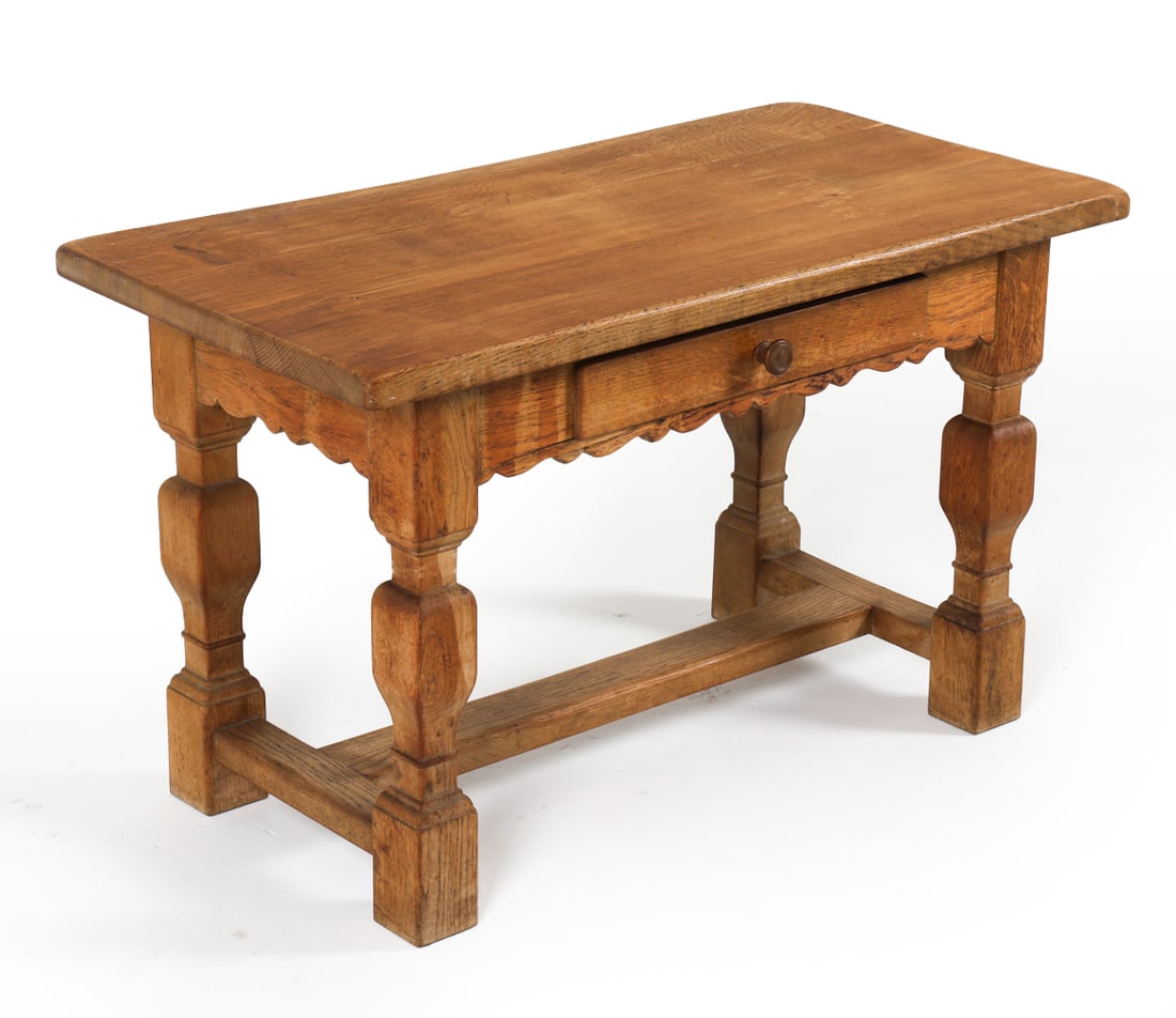 DANISH OAK SIDE OR WORK TABLE: Scalloped apron. Dimensions: H 23" x W 37.75" x D 19.5" Condition: Moderate water blemishes to frame and legs. Rubbing to edges. Stress cracks to scalloped apron. Wear consistent with age and use. DMQ