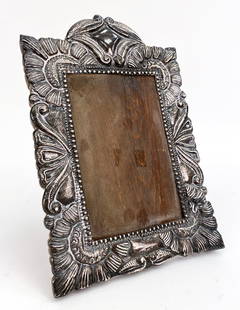PERUVIAN STERLING SILVER PICTURE FRAME: Wooden frame with a sterling overlay to the front side. Marked on lower edge of sterling. Dimensions: H 11.25" x W 7.5" x D 0.75" Condition: Bends and Tarnish to silver. Rubs and scuffs to wood.