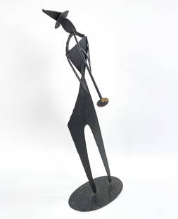METAL MUSICIAN SCULPTURE: Decorative metal sculpture depicting a figure playing an instrument. Dimensions: H 31.5" x W 15" Condition: Wear consistent with age. Minor paint loses on the stand and at the end of the bugle.