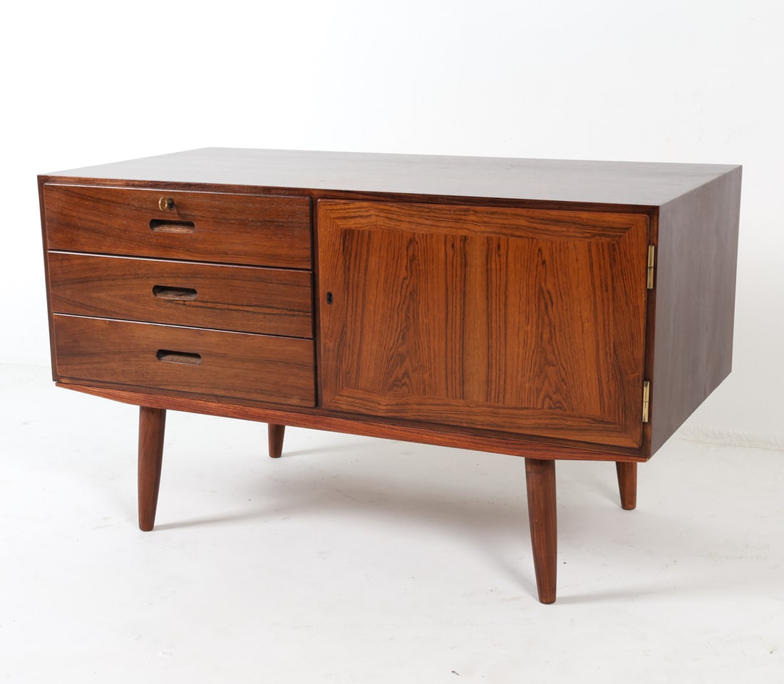 DANISH ROSEWOOD CABINET C. 1960S: Key included. Curved inset drawer pulls. Adjustable shelves. Dimensions: H 25.5" x W 43.5" x D 21.75". Condition: Minor light surface scratches, presents well overall. D121