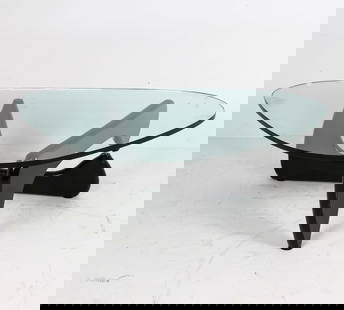 ISAMU NOGUCHI GLASS TOP COFFEE TABLE: Designed by Isamu Noguchi (1904-1988). Signed to edge of glass. Glass top in organic shape on wooden legs. Dimensions: H 15.5" x W 51" x D 37". Condition: Minor scuffs to glass and wooden legs. Wear c