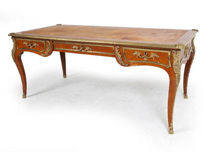 ANTIQUE FRENCH LOUIS XV STYLE ORMOLU DESK: With brass ormolu to legs and tabletop. Tooled leather top. Dimensions: H 30" x W 71" x D 34" Condition: Moderate blemishes to leather top. No key. Ormolu accents loose to edges and drawer fronts. Wea