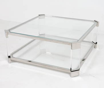 MITCHELL GOLD BELROSE NICKEL & LUCITE COFFEE TABLE: 2 tiered glass table with nickel frame with lucite side panels. Dimensions: H 16" x W 38" x D 38" Condition: Faint scuffs to nickel and lucite. Presents well overall.